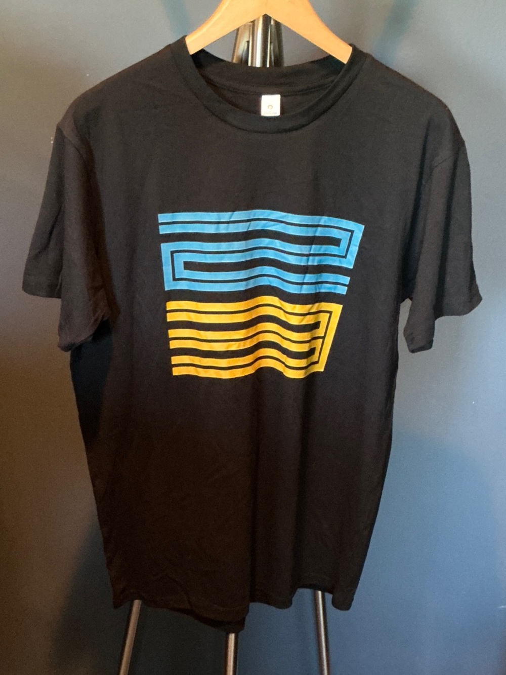 NWOT Black Graphic Tee with Blue and Yellow Stripe Design